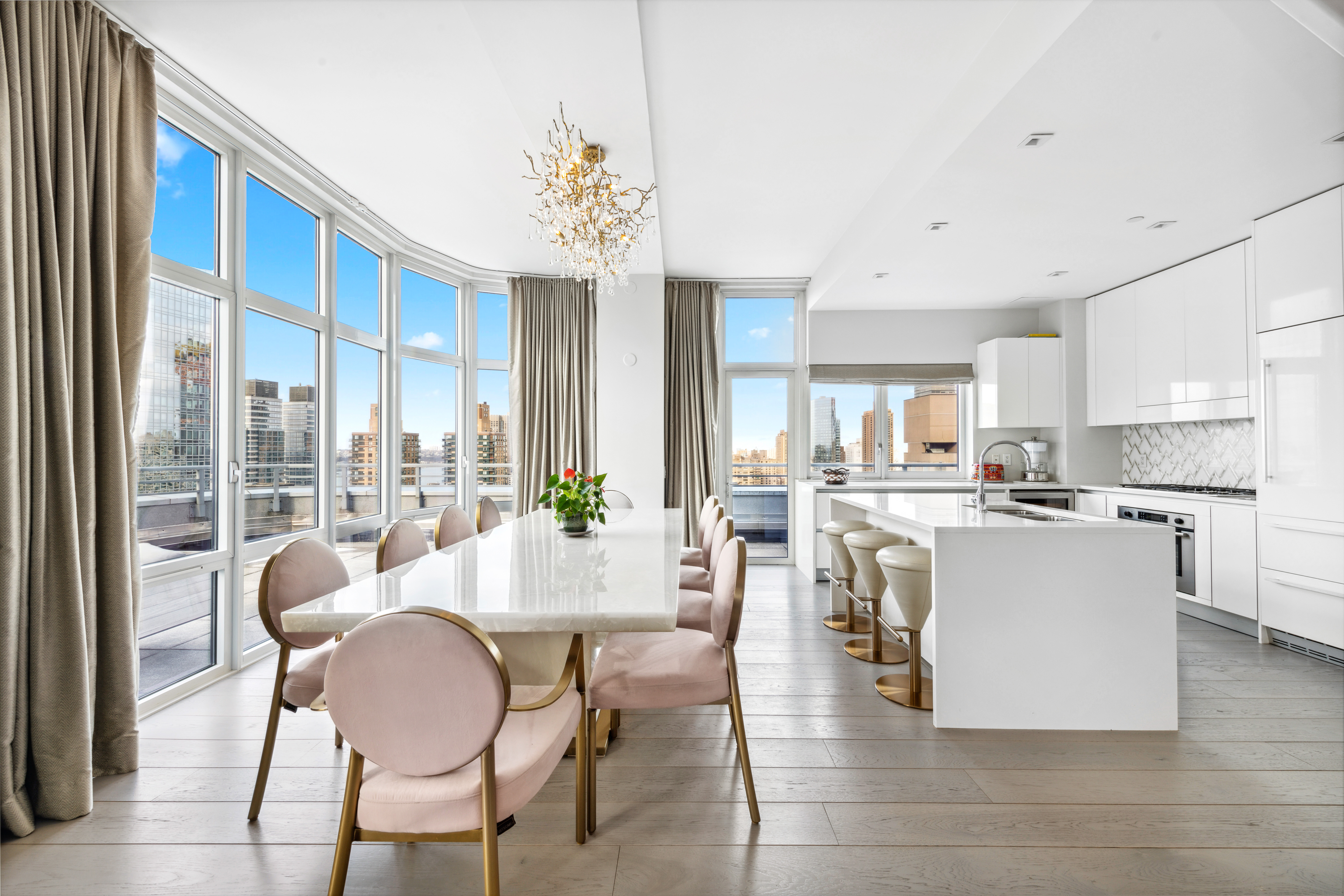 555 West 59th Street, Unit PHA Manhattan, NY 10019 - Photo 3 of 20 a large kitchen with a table and chairs