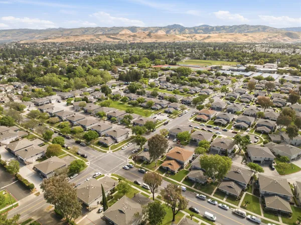 an aerial view of residential houses with outdoor space