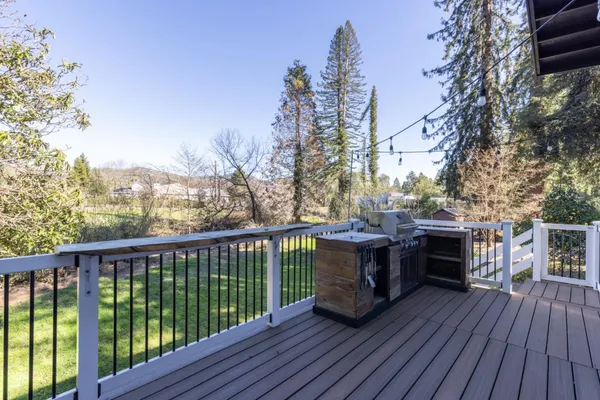 a view of a balcony with furniture and wooden floor