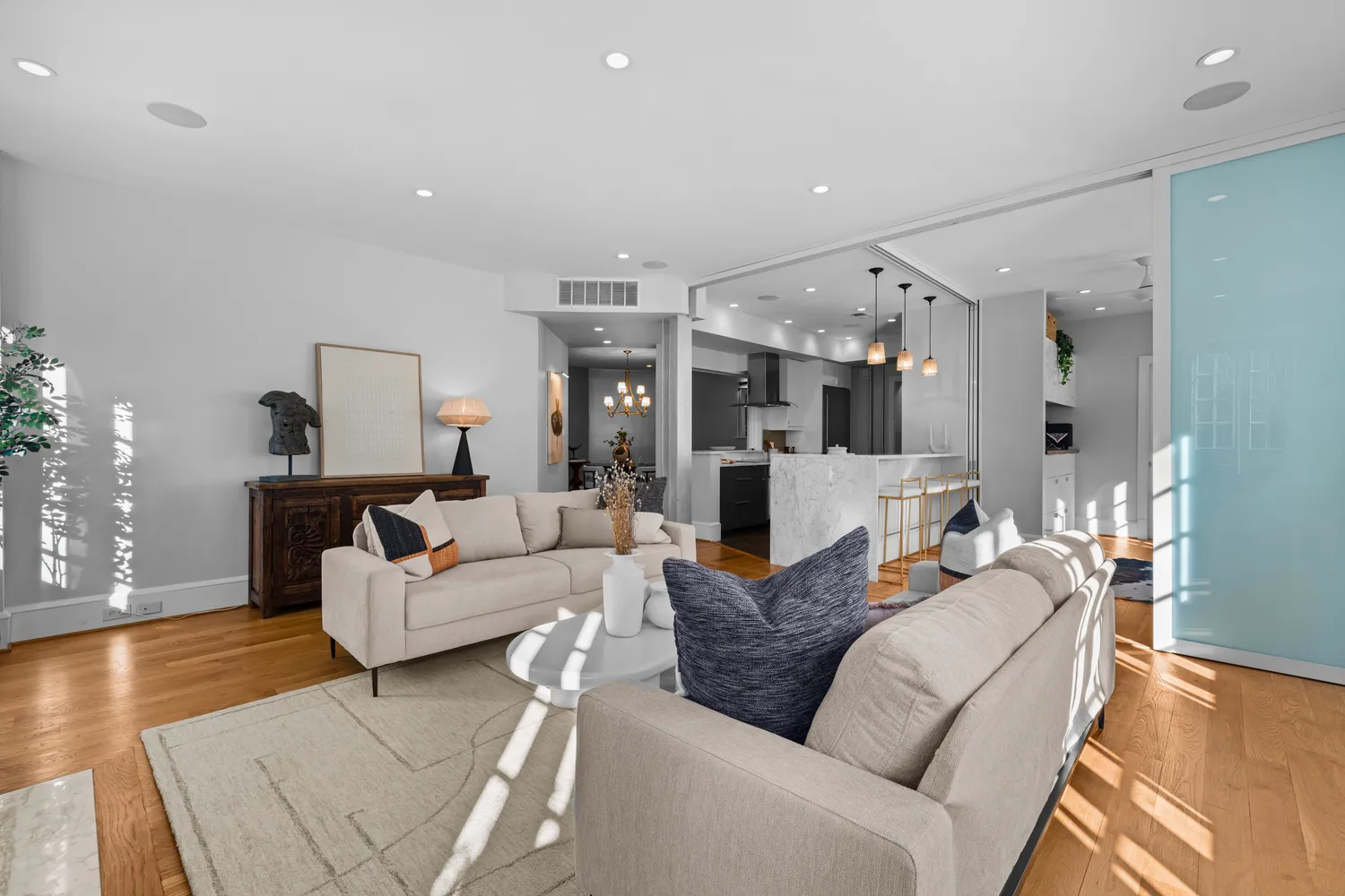 a living room with furniture and wooden floor