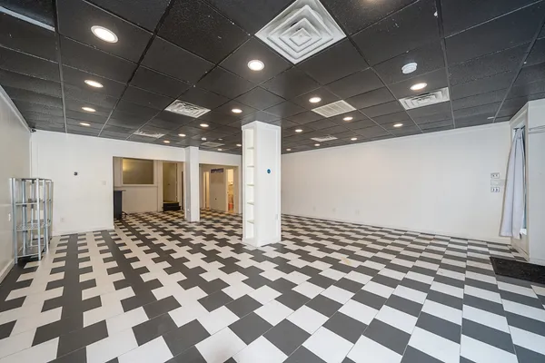a bathroom with a black and white checkered floor