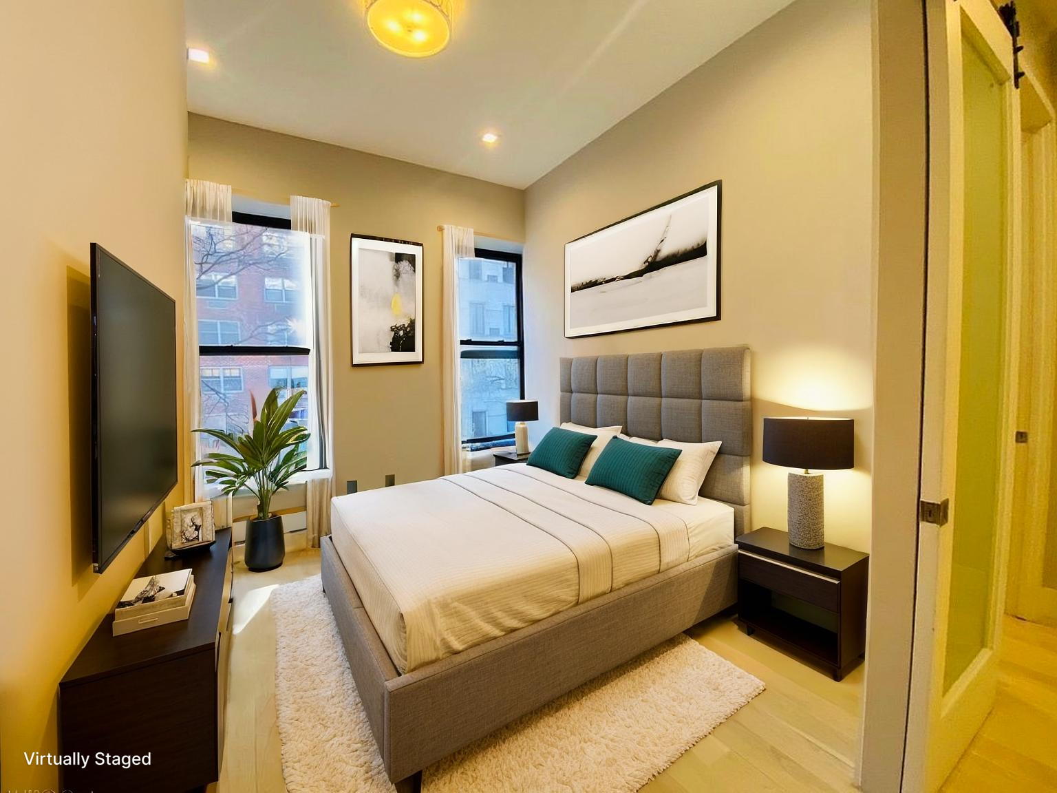 133 East 35th Street, Unit 3 Manhattan, NY 10016 - Photo 2 of 16 a bedroom with a bed and a flat screen tv