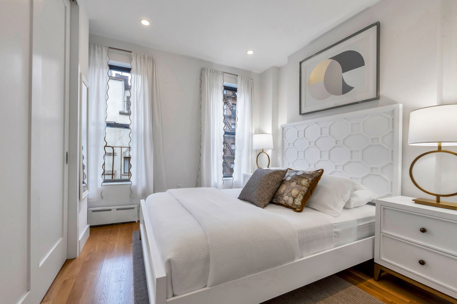 223 West 10th Street, Unit 2C Manhattan, NY 10014 - Photo 3 of 11 a bedroom with a bed and wooden floor