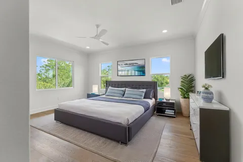 a spacious bedroom with a large bed and a flat screen tv