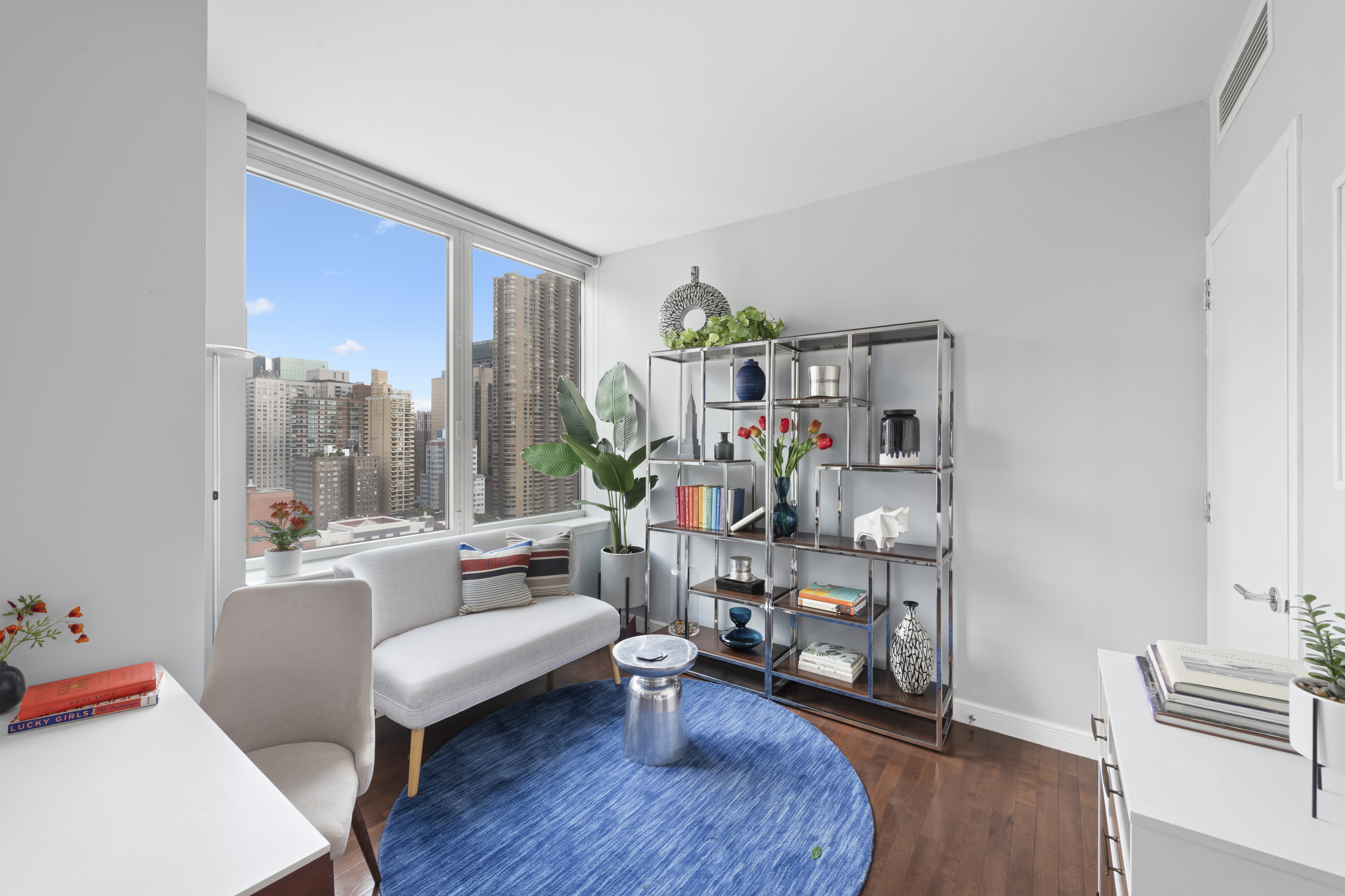 225 East 34th Street, Unit 21I Manhattan, NY 10016 - Photo 4 of 24 a living room with furniture and a wooden floor