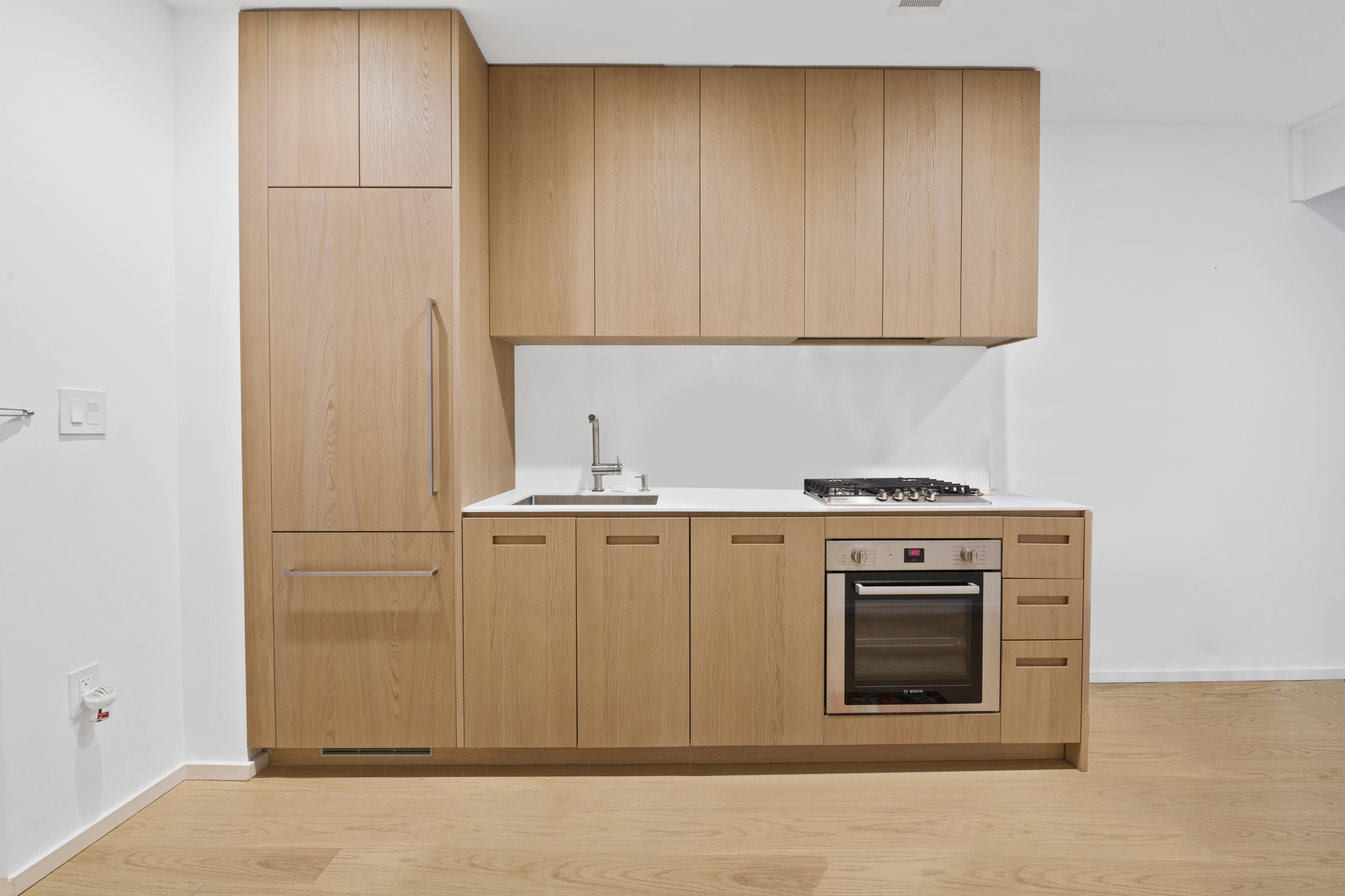 98 Front Street, Unit 4A Brooklyn, NY 11201 - Photo 3 of 6 a kitchen with white cabinets and white appliances