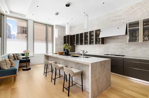 a kitchen with stainless steel appliances kitchen island granite countertop a sink and cabinets