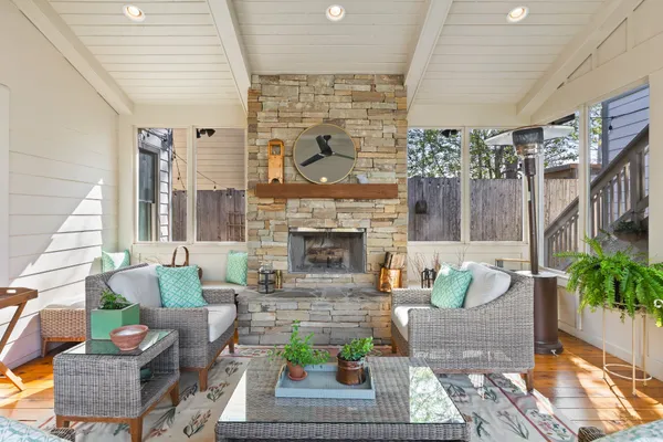 a living room with patio furniture and a fireplace