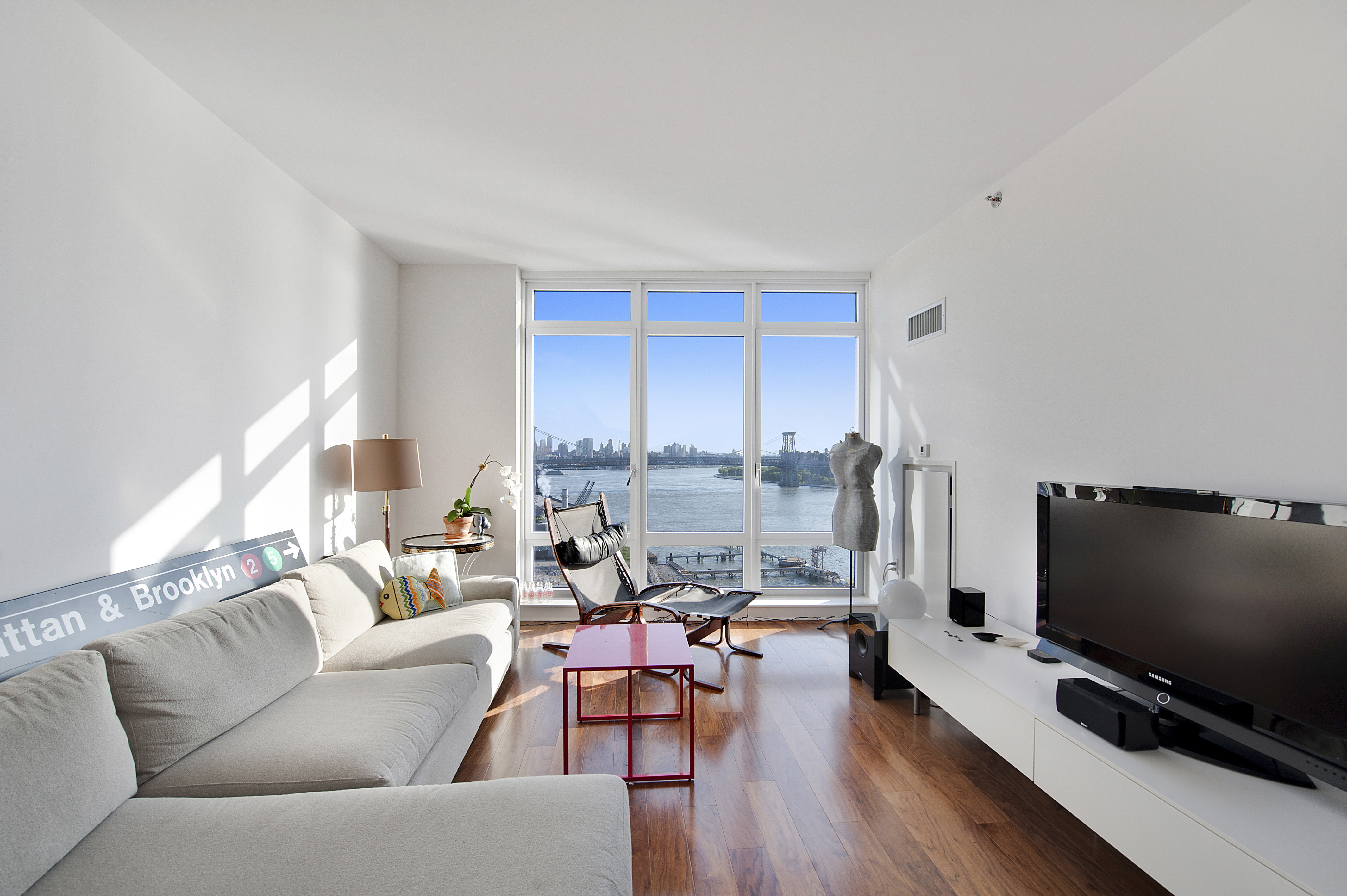 2 Northside Piers, Unit 21B Brooklyn, NY 11249 - Photo 1 of 11 a living room with furniture and a flat screen tv