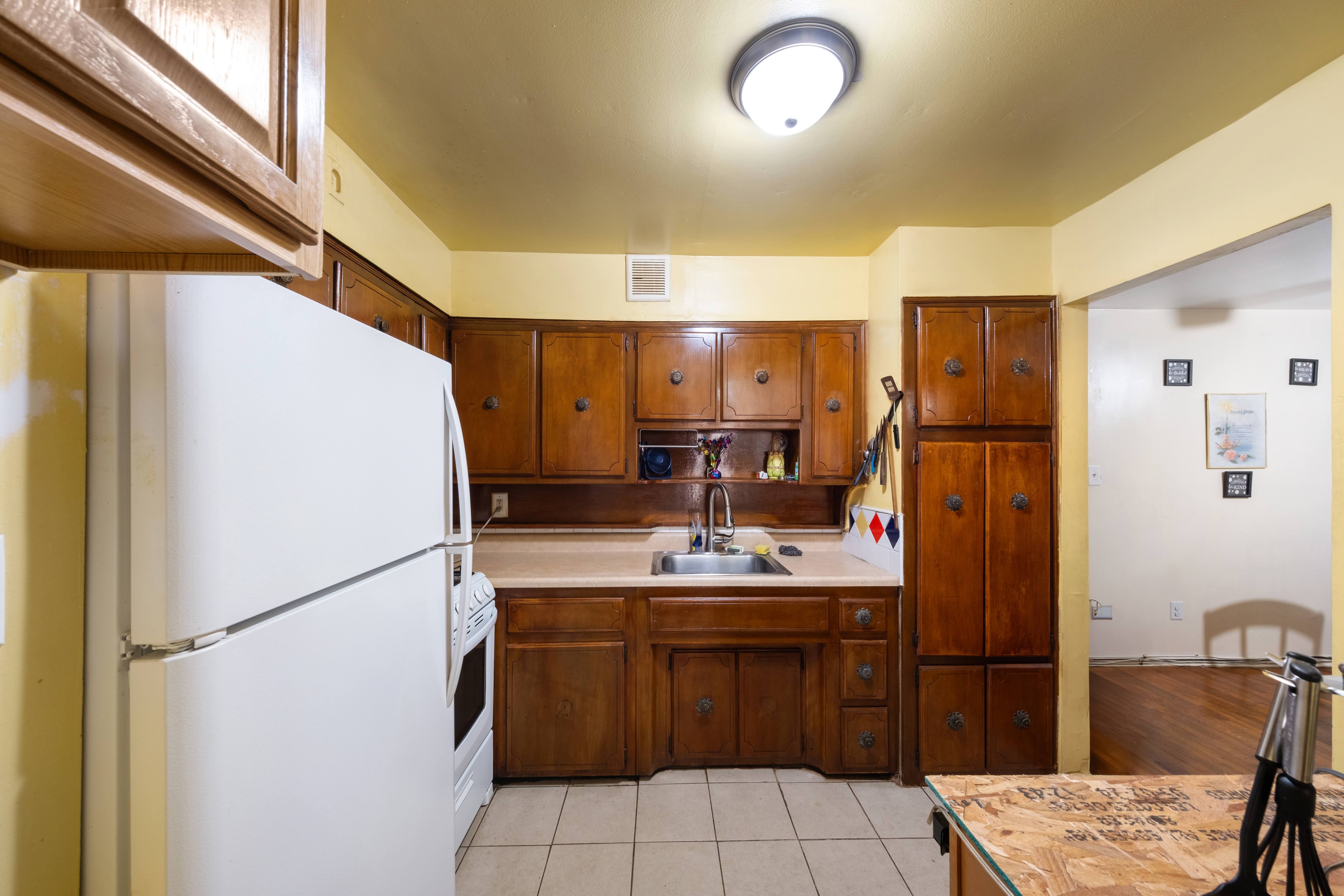 1464 East 84th Street Brooklyn, NY 11236 - Photo 16 of 22 a kitchen with a refrigerator and countertop