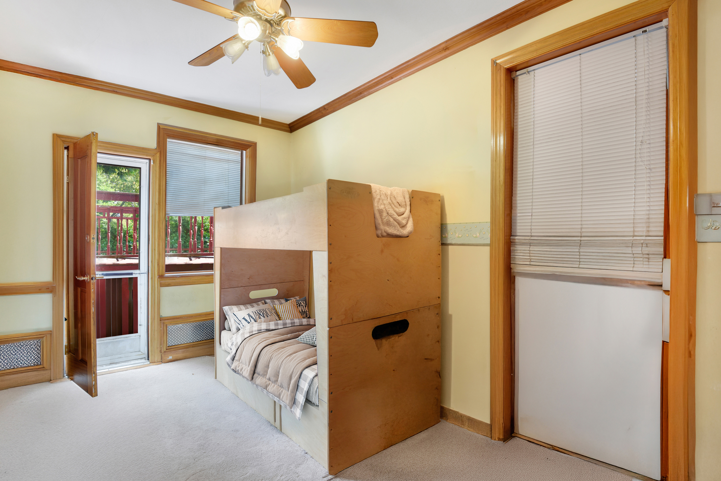 233 Battery Avenue Brooklyn, NY 11209 - Photo 6 of 17 a bed room with a bed and a chandelier