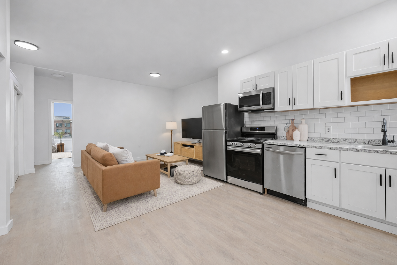 131 20th Street, Unit MULTI Brooklyn, NY 11232 - Photo 4 of 16 a kitchen with granite countertop a sink cabinets and stainless steel appliances