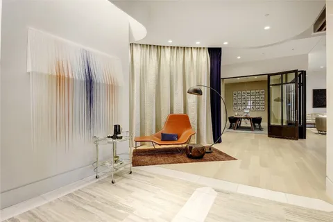 a view of a hallway with dining area and windows