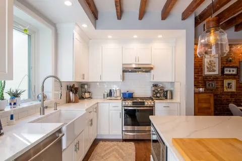 a kitchen with stainless steel appliances a sink stove and cabinets