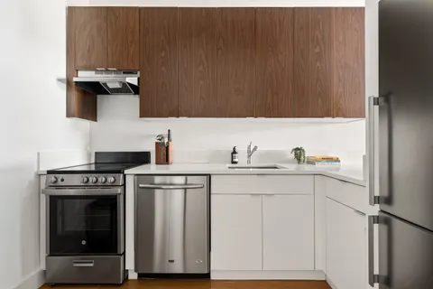 a kitchen with cabinets and a stove