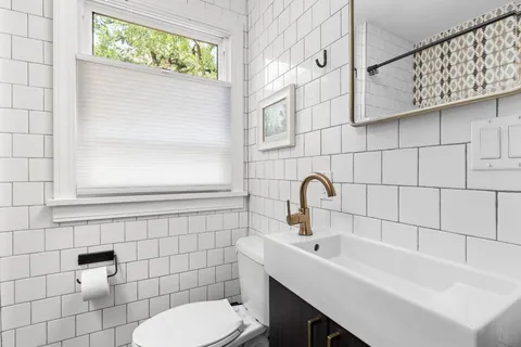 a bathroom with a sink a toilet and a shower