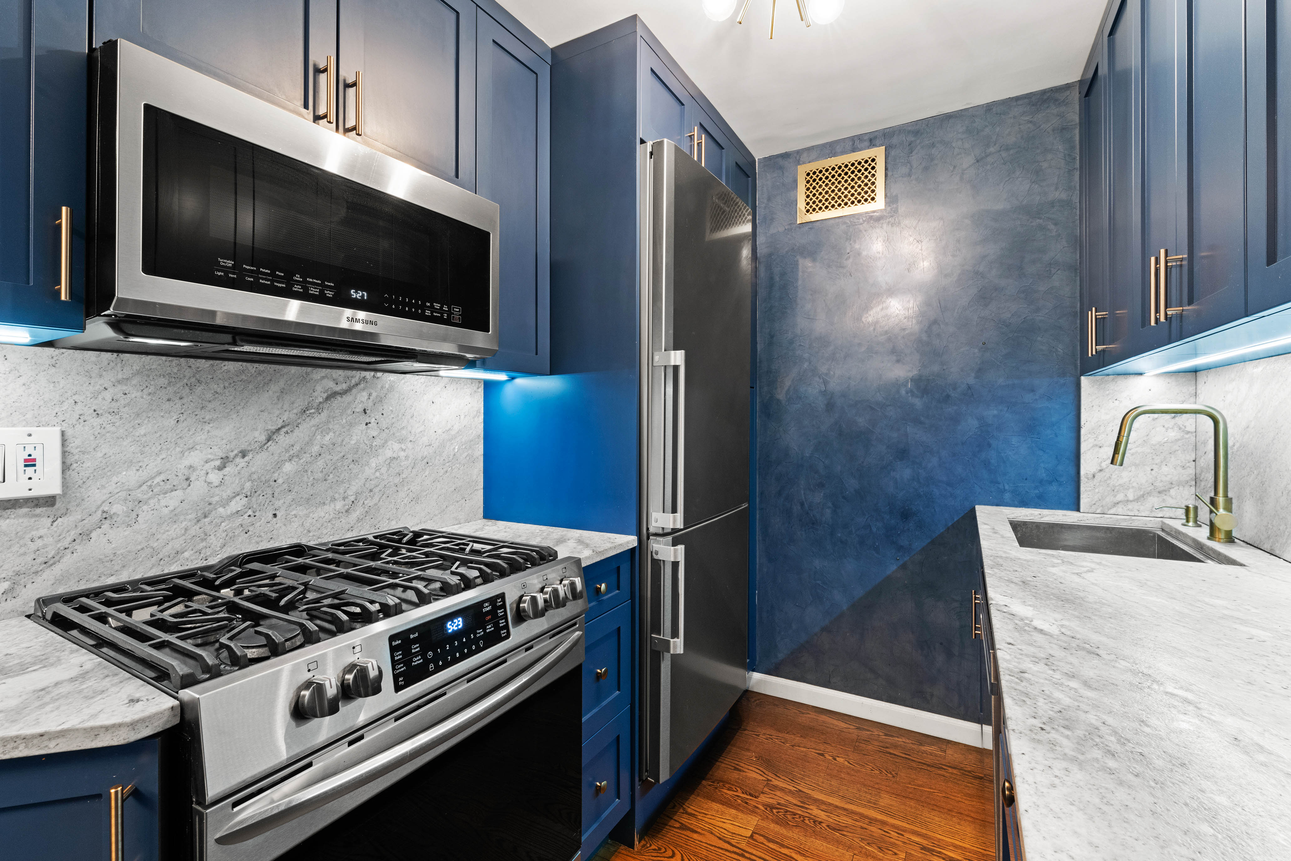 102-10 66th Road, Unit K25 Queens, NY 11375 - Photo 7 of 19 a kitchen with a stove and a microwave