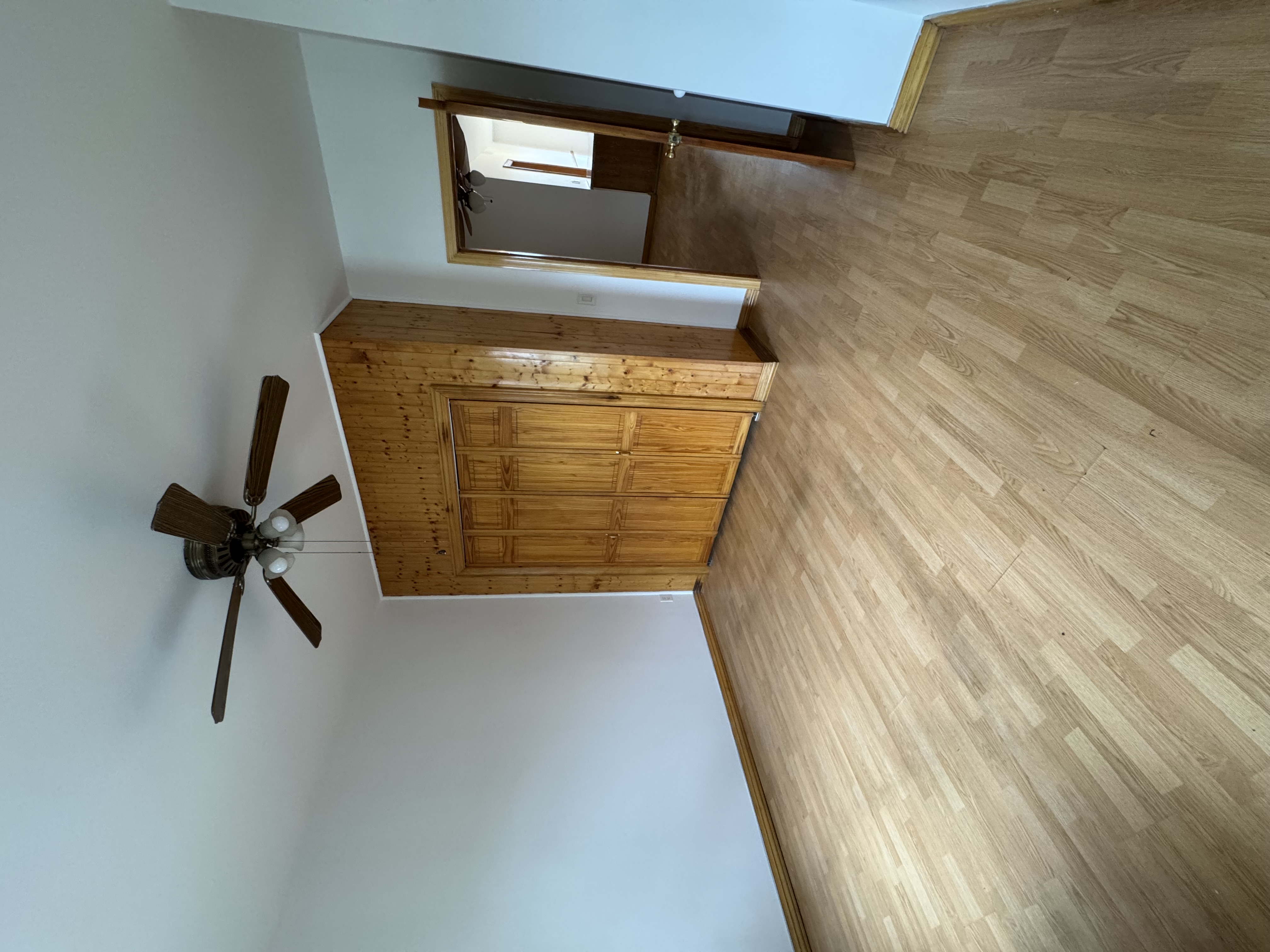 60-27 56th Road, Unit 3 Queens, NY 11378 - Photo 3 of 9 a view of empty room with wooden floor