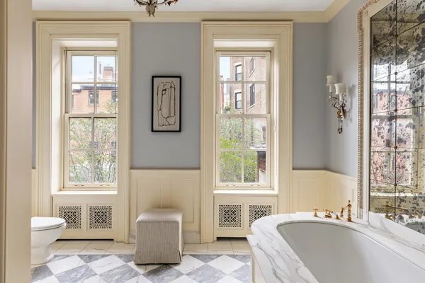 a bedroom with furniture and a large window