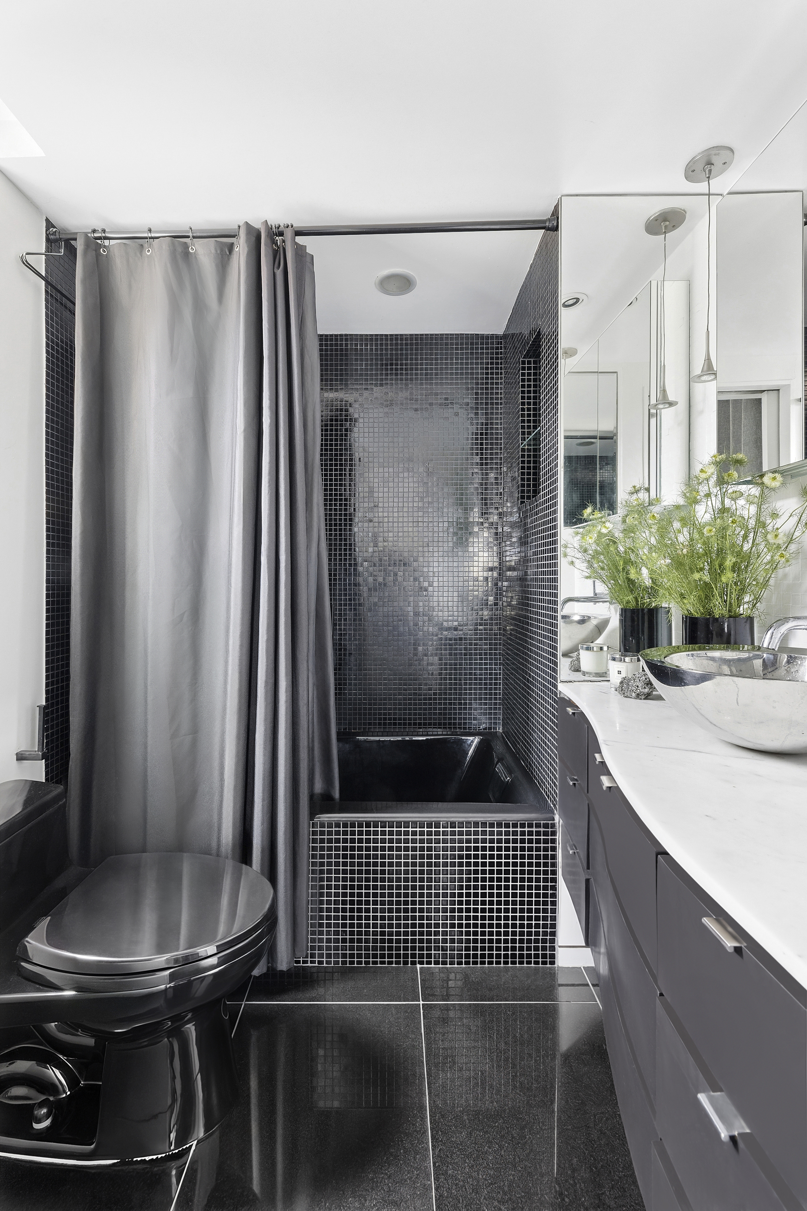 105 West 13th Street, Unit 16F Manhattan, NY 10011 - Photo 5 of 12 a bathroom with a sink and a mirror