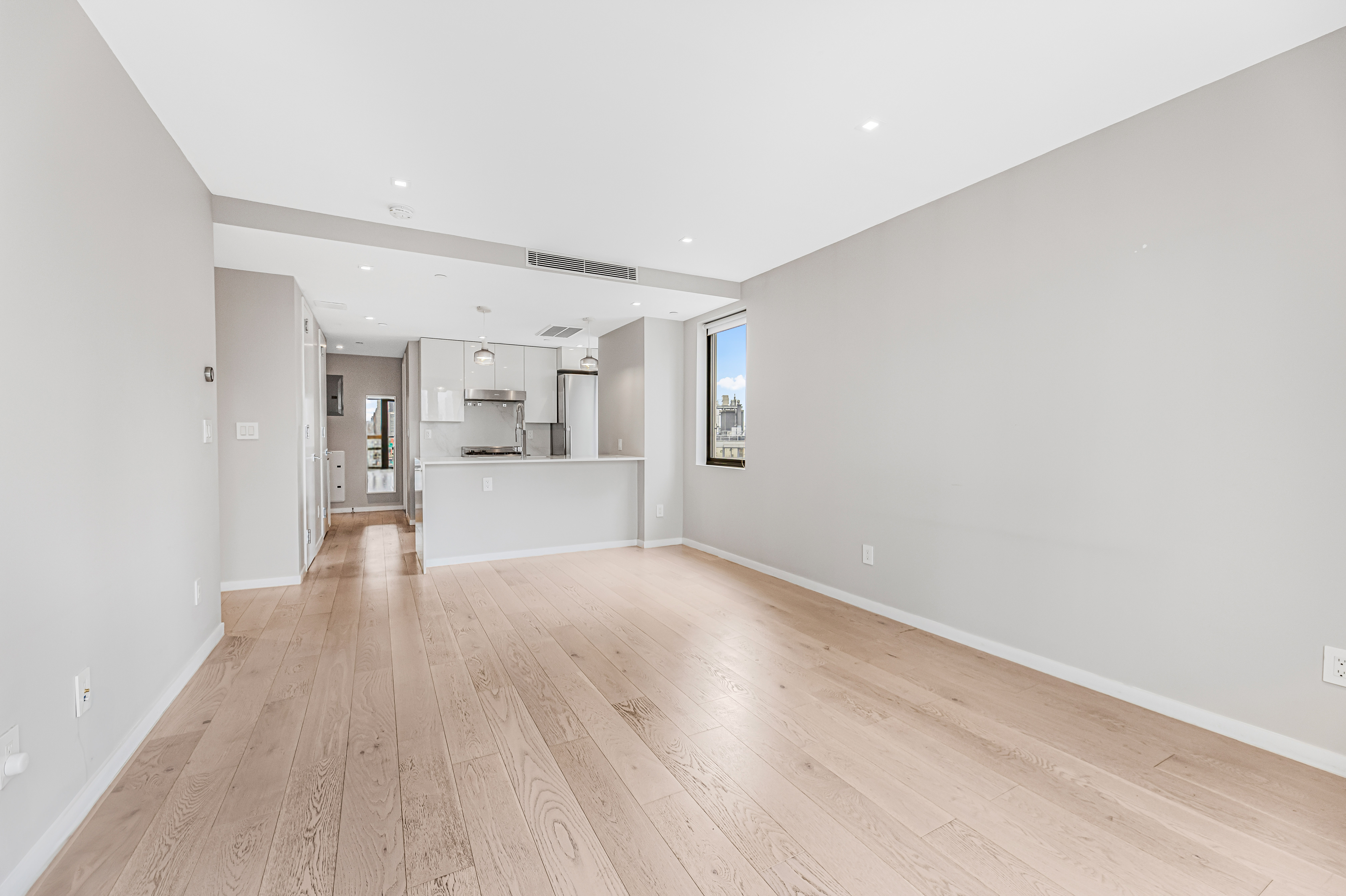 42-50 27th Street, Unit 9C Queens, NY 11101 - Photo 21 of 32 a view of a livingroom with wooden floor