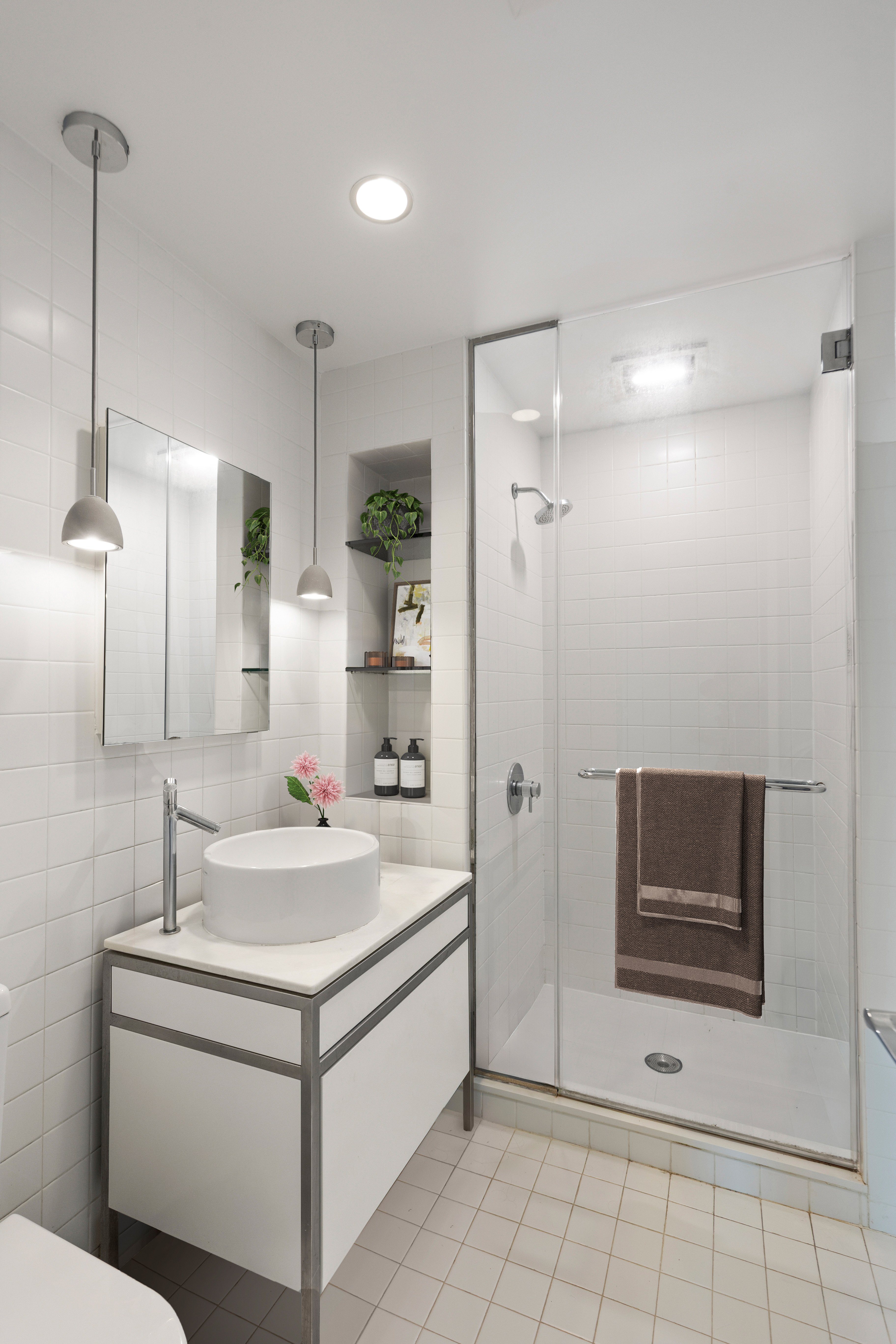 15 Broad Street, Unit 3100 Manhattan, NY 10005 - Photo 7 of 27 a bathroom with a sink a toilet and shower