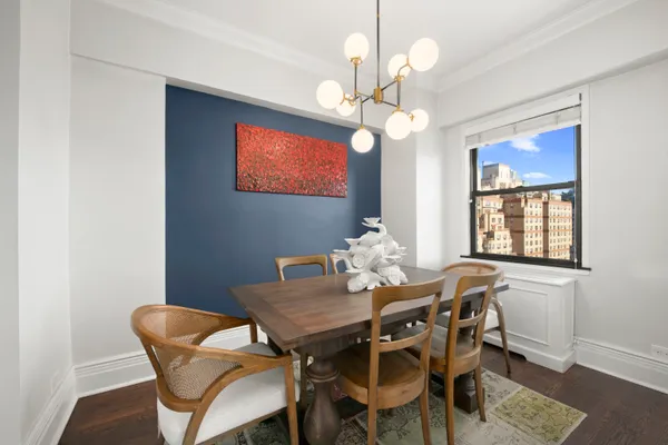 a view of a dining room with furniture and chandelier