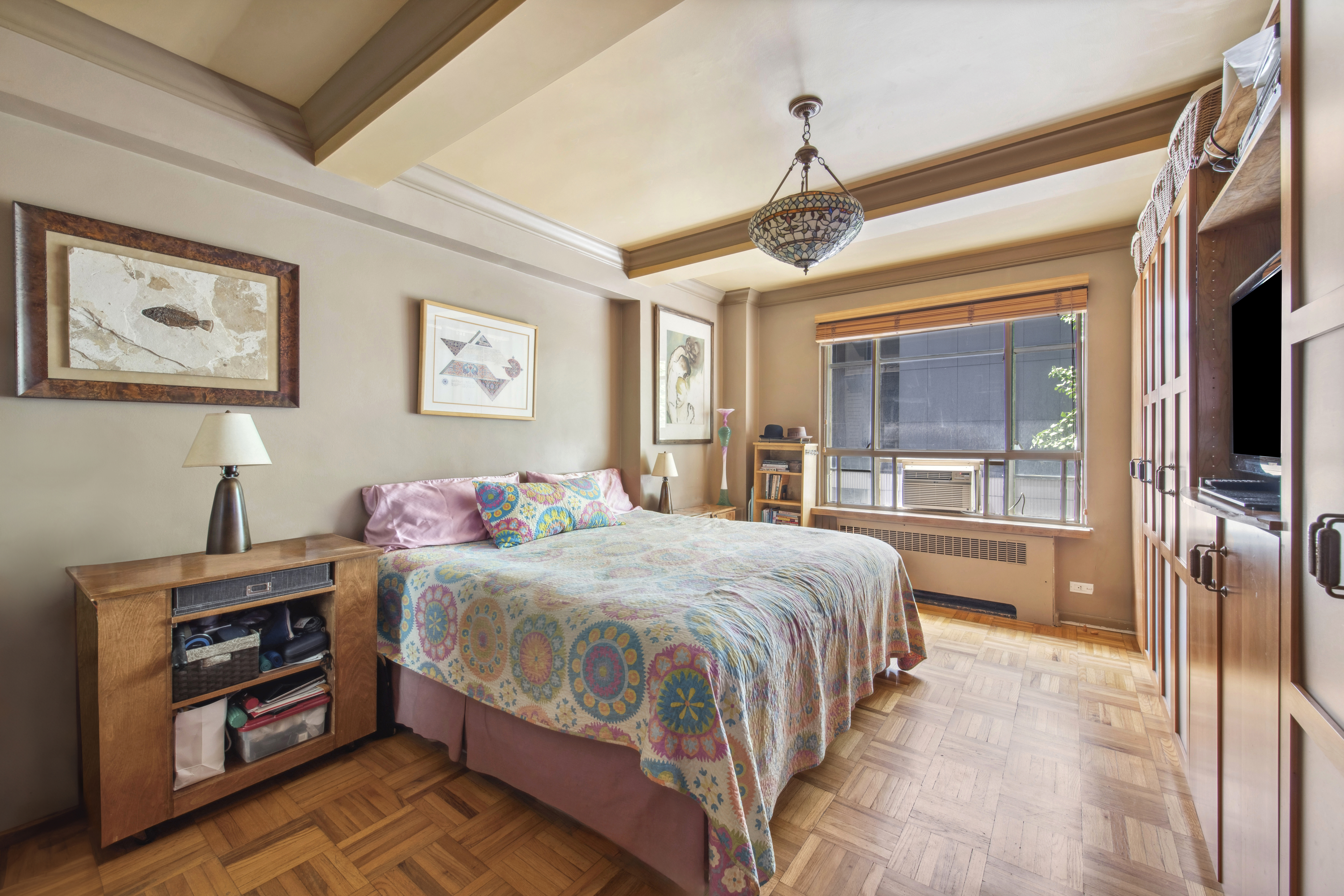 45 West 54th Street, Unit 3CD Manhattan, NY 10019 - Photo 6 of 14 a bedroom with a bed and a flat screen tv