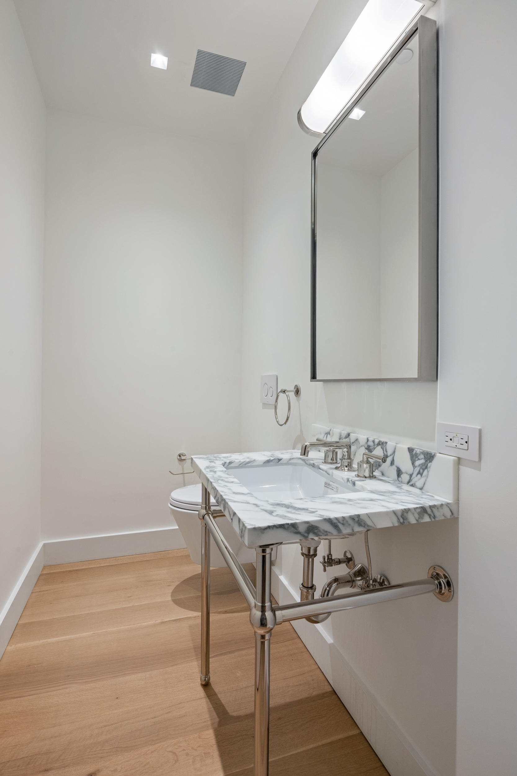 243 West Broadway, Unit 3 Manhattan, NY 10013 - Photo 23 of 25 a bathroom with a sink and a mirror