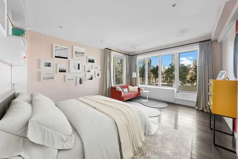 a bedroom with a bed wooden floor and window