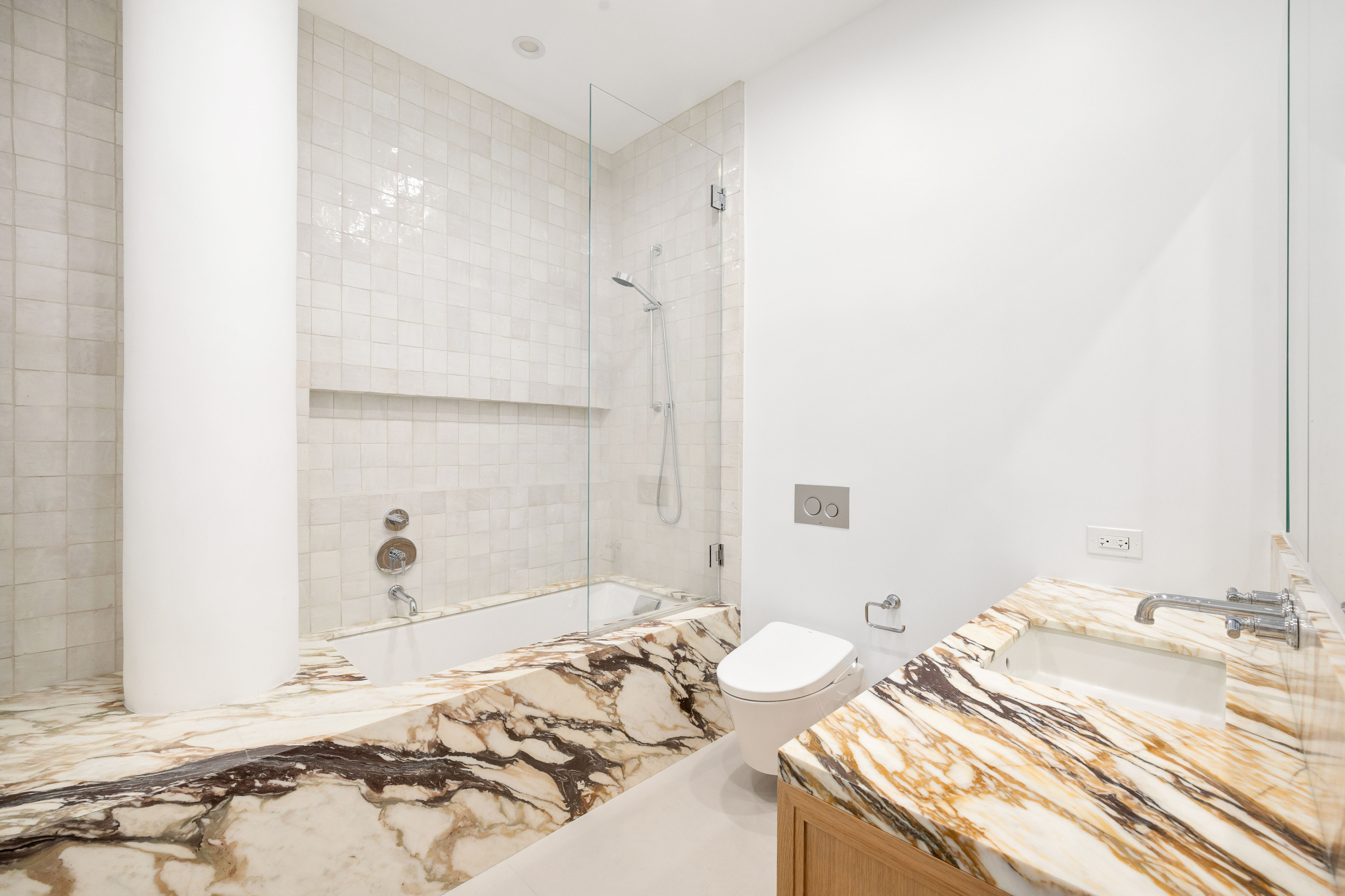 69 Bank Street, Unit 203 Manhattan, NY 10014 - Photo 11 of 23 a bathroom with a sink and a mirror