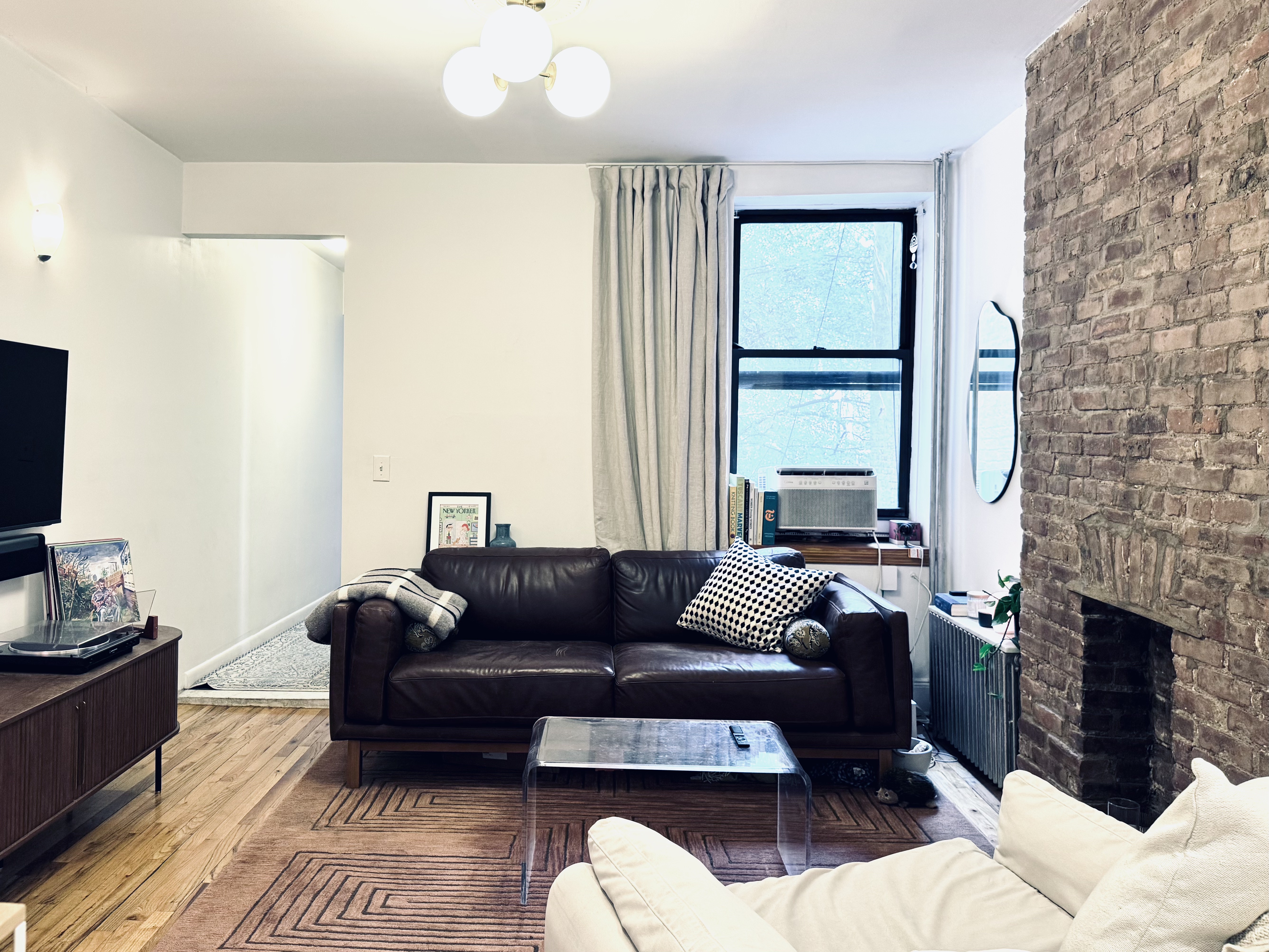 347 5th Avenue, Unit 2R Brooklyn, NY 11215 - Photo 2 of 7 a living room with furniture a fireplace and a flat screen tv