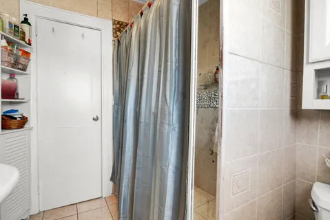 a bathroom with a shower and a toilet
