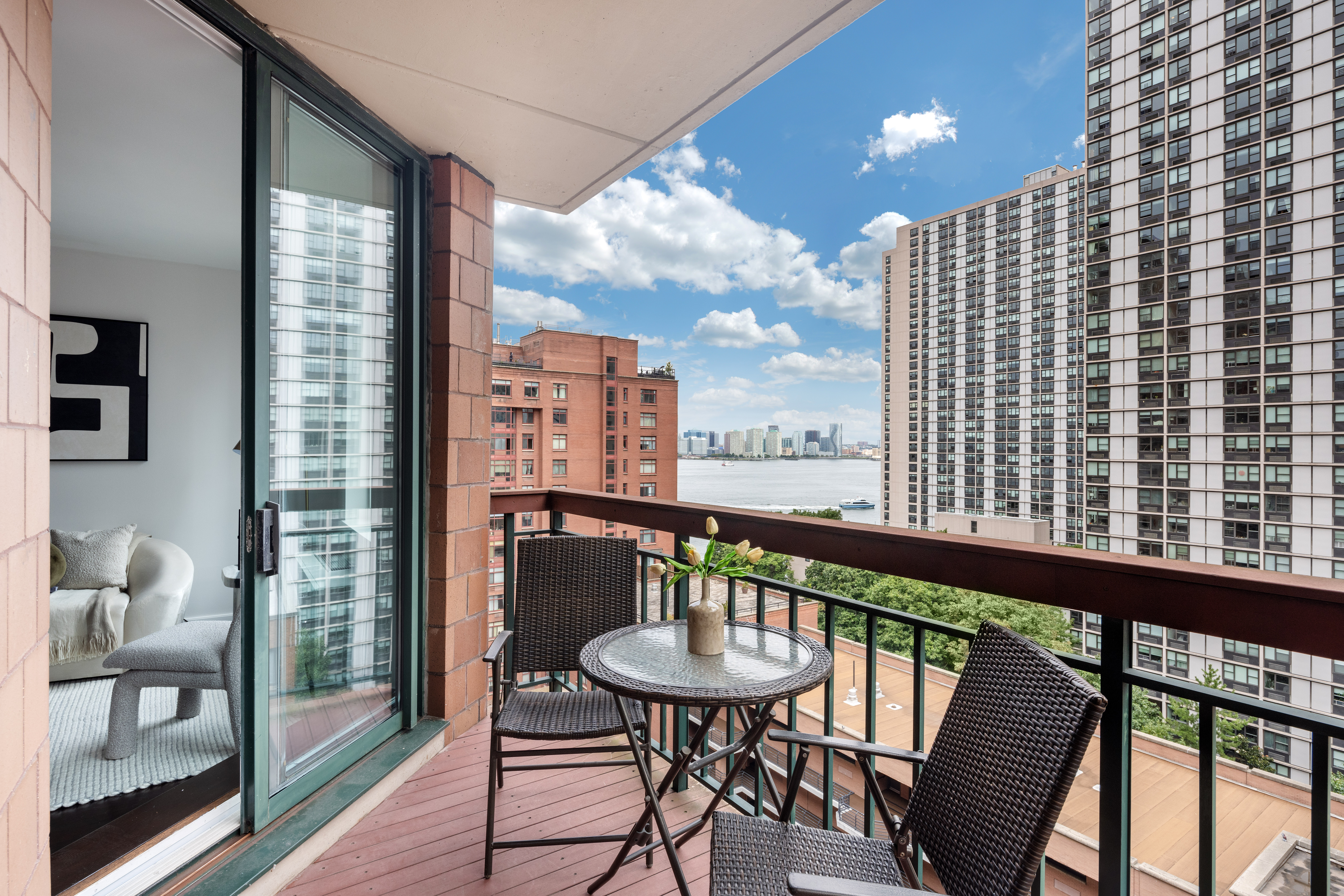 333 Rector Place, Unit 1401 Manhattan, NY 10280 - Photo 6 of 9 a view of a balcony with furniture