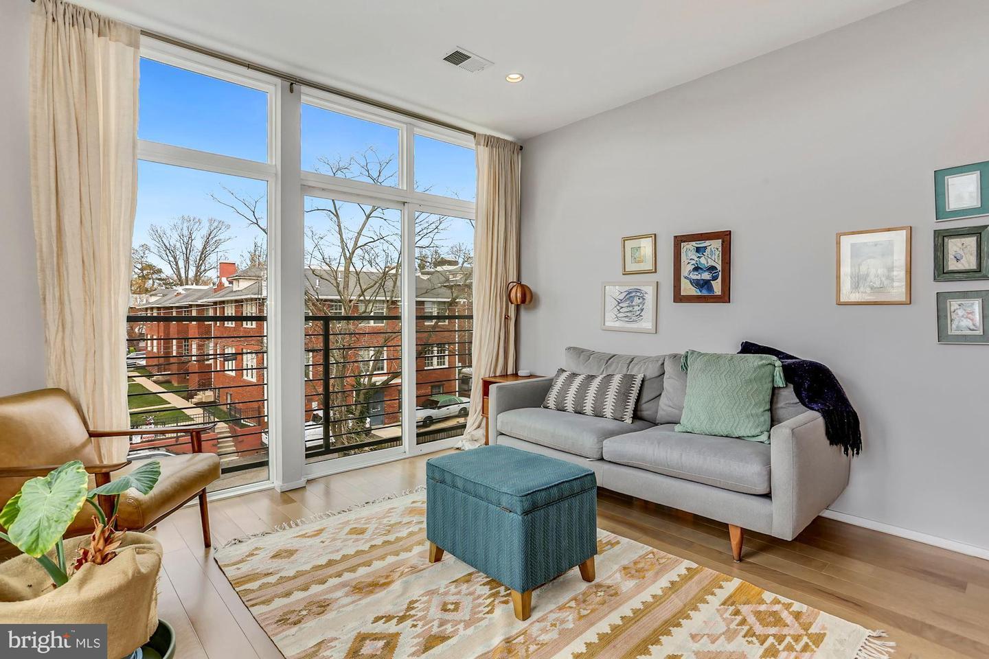 129 Varnum Street Northwest, Unit 6 Washington, DC 20011 - Photo 14 of 25 a living room with furniture and a floor to ceiling window