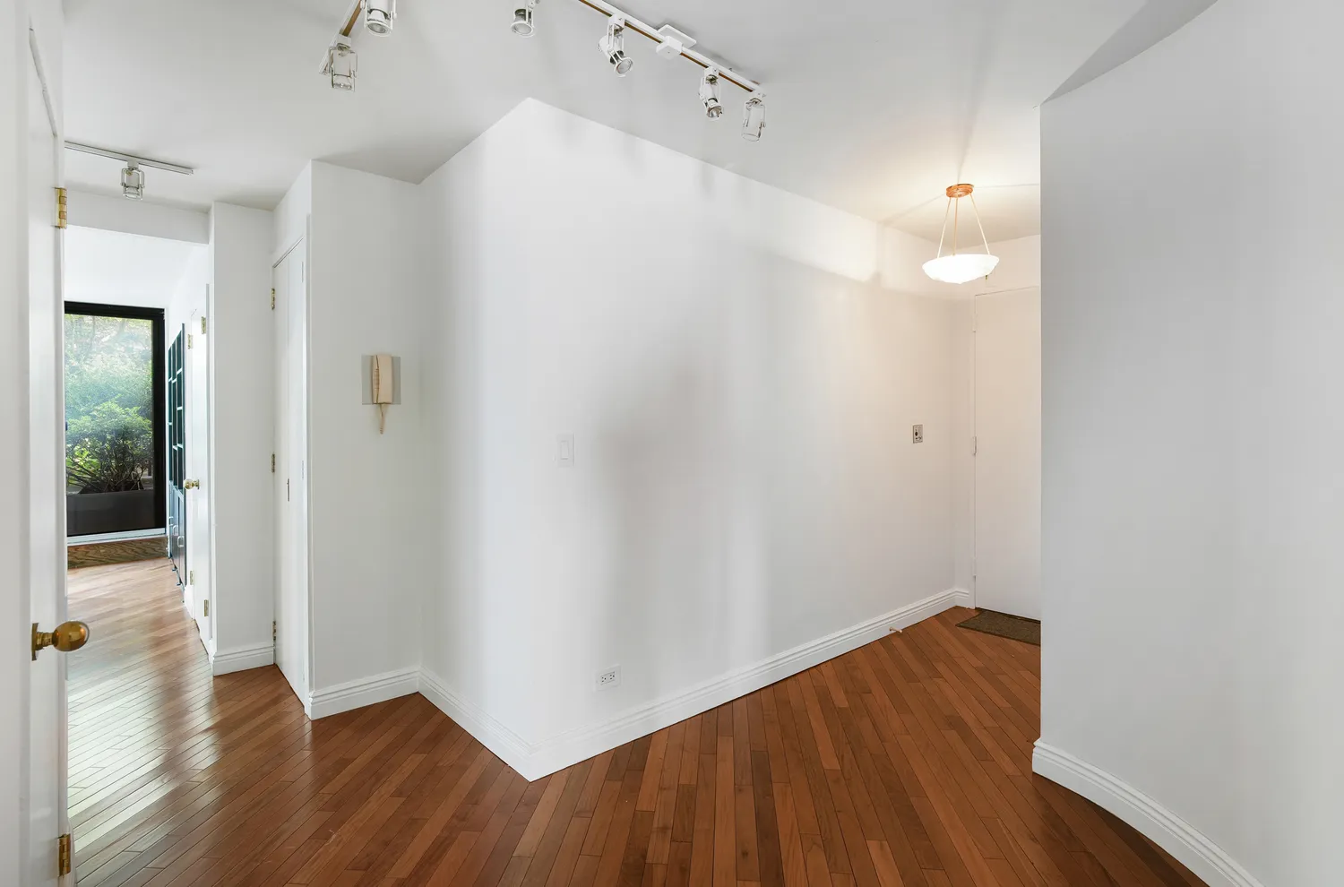 a view of a room with wooden floor