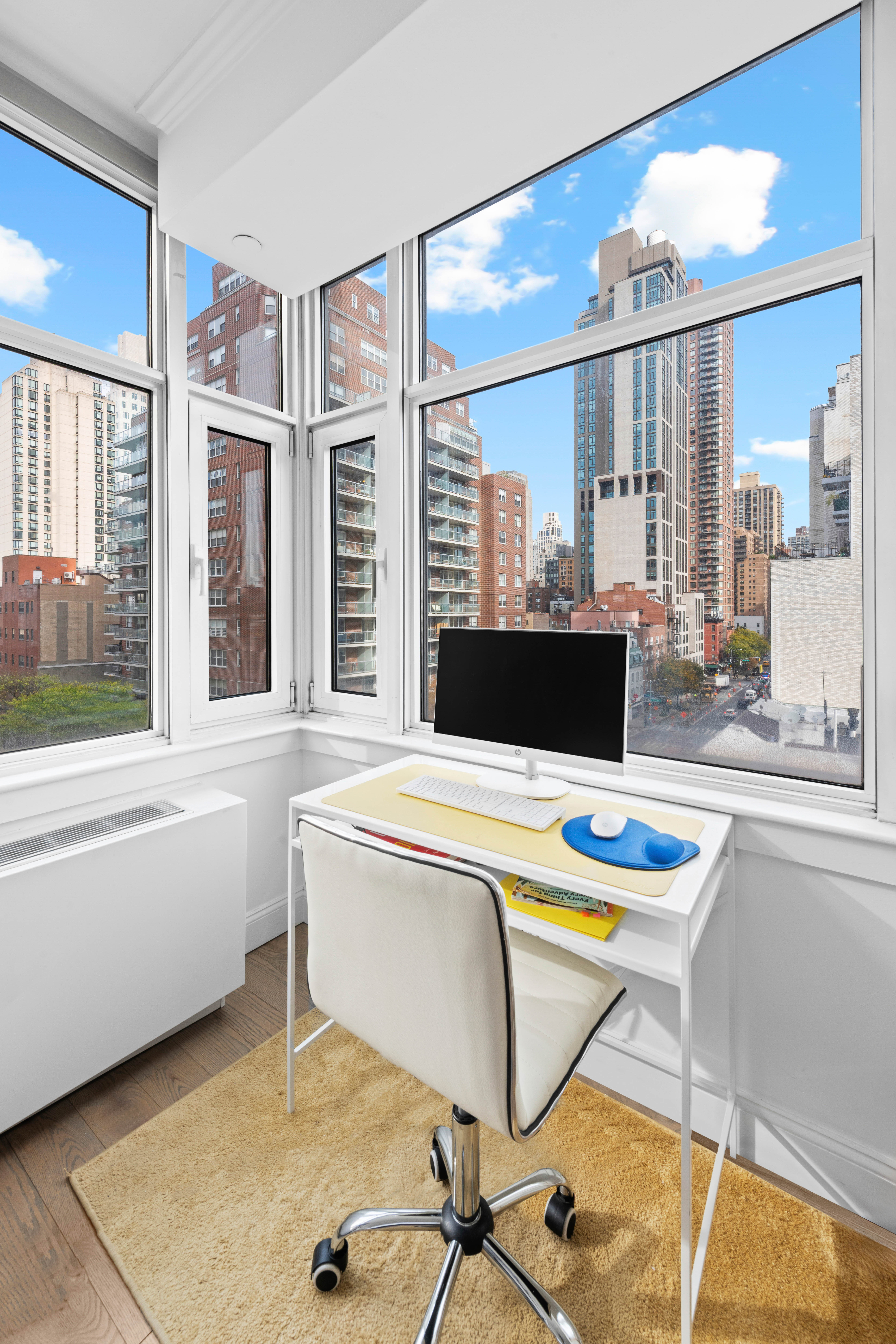 404 East 76th Street, Unit 8A Manhattan, NY 10021 - Photo 9 of 17 a view of a dining room with furniture wooden floor and a large window