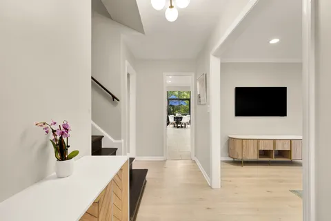 a view of an entryway with wooden floor and door