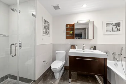 a bathroom with a sink toilet and shower
