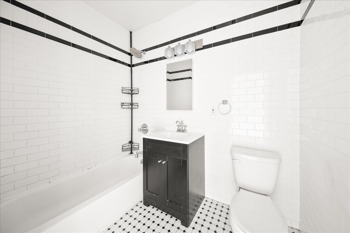 478 Halsey Street, Unit 1 Brooklyn, NY 11233 - Photo 9 of 10 a bathroom with a sink a toilet and shower