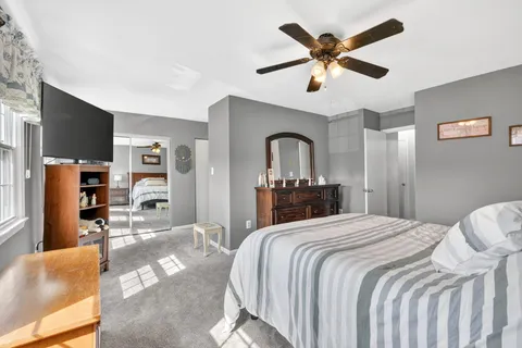 a bedroom with a bed and a desk