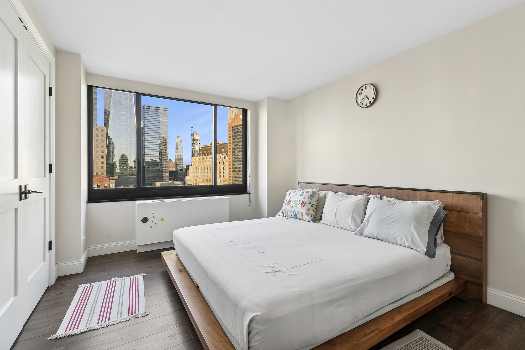 200 Rector Place, Unit 26B Manhattan, NY 10280 - Photo 4 of 8 a bedroom with a large bed and a large window