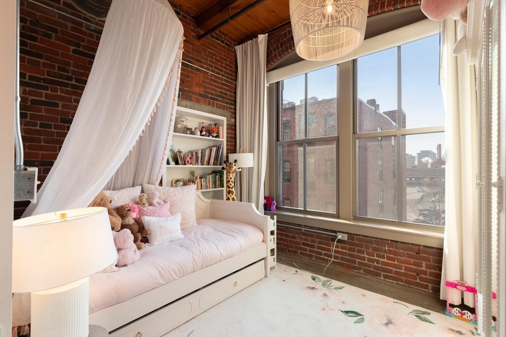 35 Channel Center Street, Unit 402 Boston, MA 02210 - Photo 22 of 35 a bedroom with a bed and a window