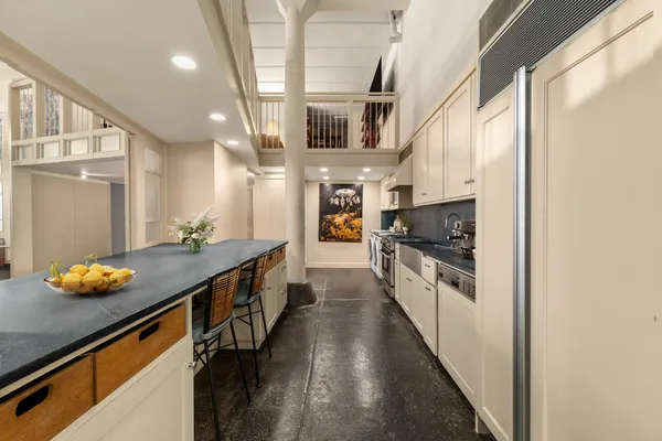 a kitchen with stainless steel appliances a sink a stove top oven a counter space and cabinets