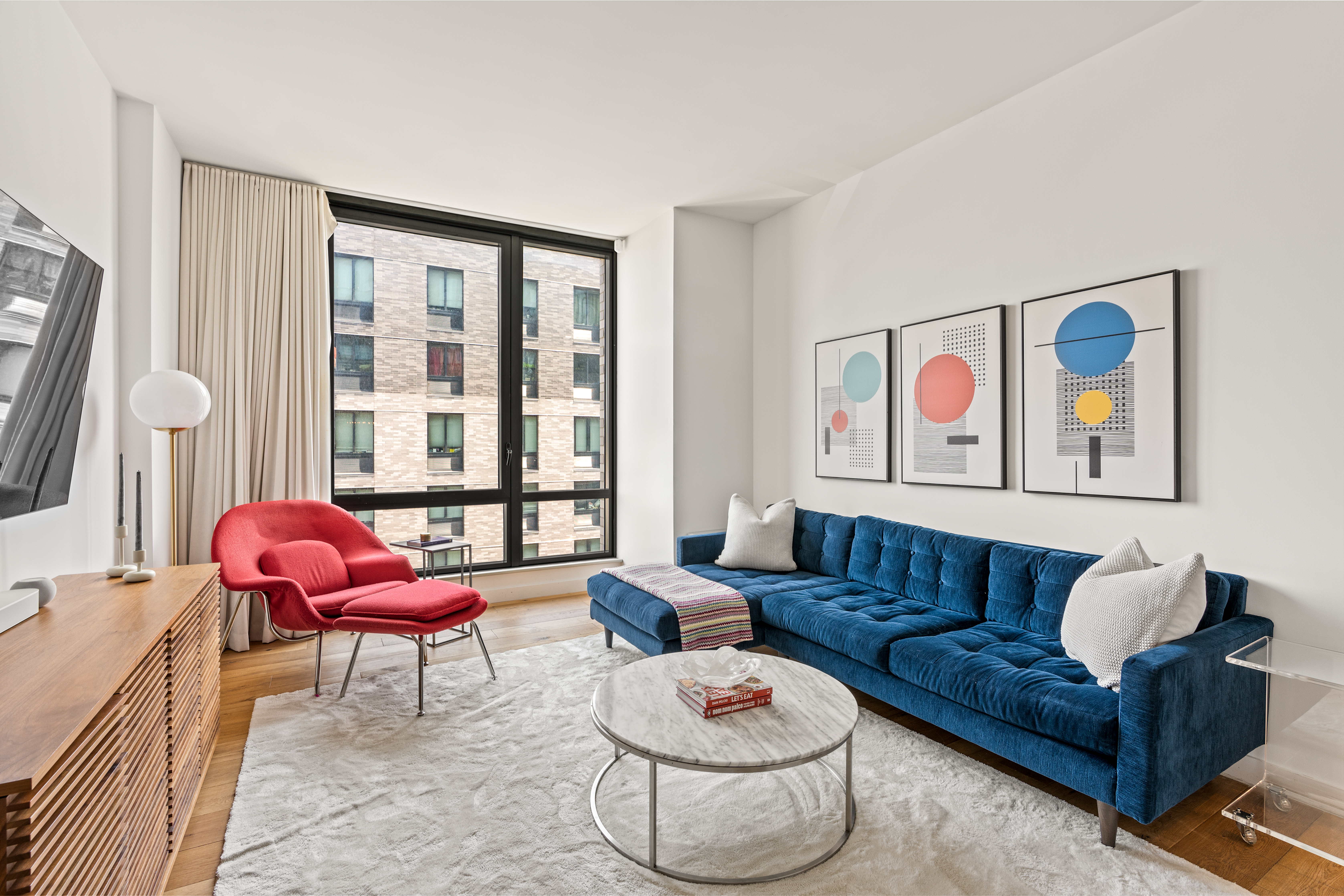 23 West 116th Street, Unit 7A Manhattan, NY 10026 - Photo 2 of 14 a living room with furniture and a large window