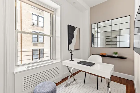 a workspace with furniture and window