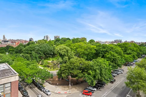 a view of a garden with a house in the background