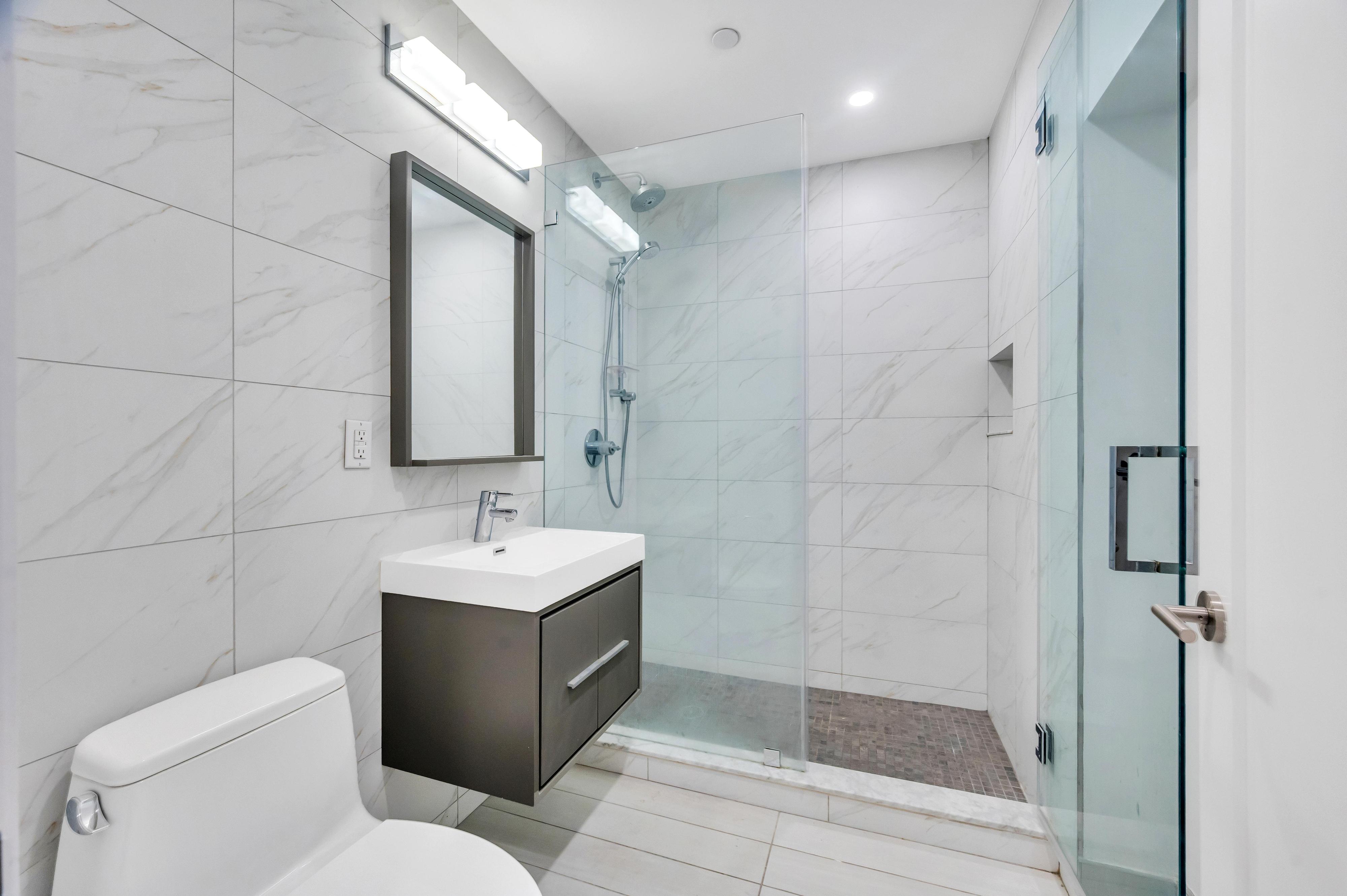 717 Manhattan Avenue, Unit 3A Brooklyn, NY 11222 - Photo 10 of 18 a bathroom with a sink toilet and shower