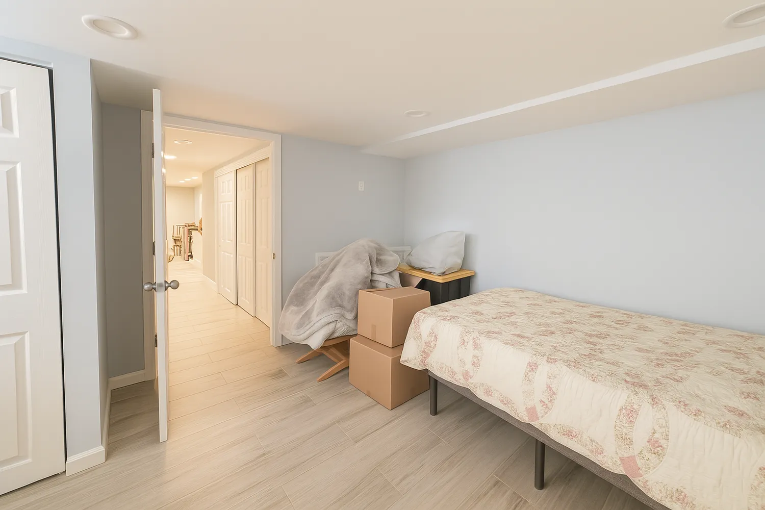 a bedroom with a bed and wooden floor