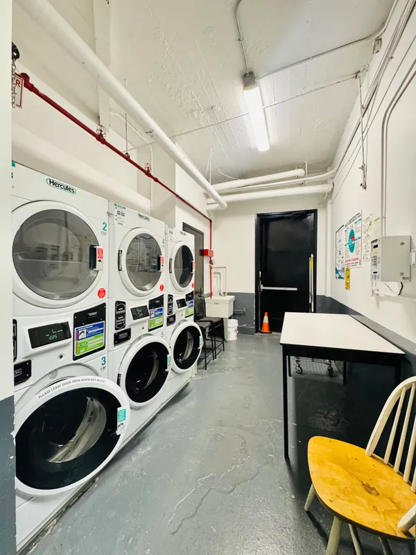 a utility room with dryer washer and cabinets
